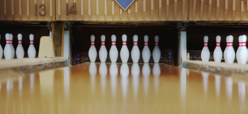 Bowling pins reflecting in bowling alley lane