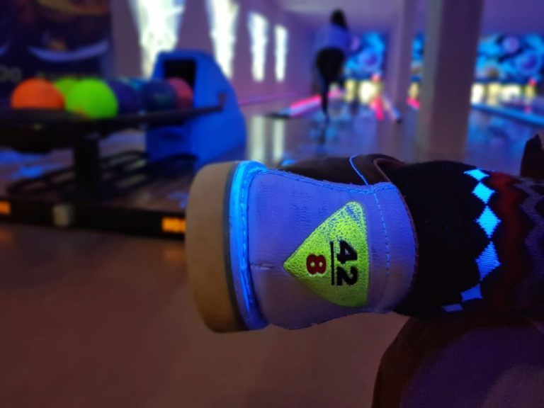Close-up image of bowling shoe in bowling alley.