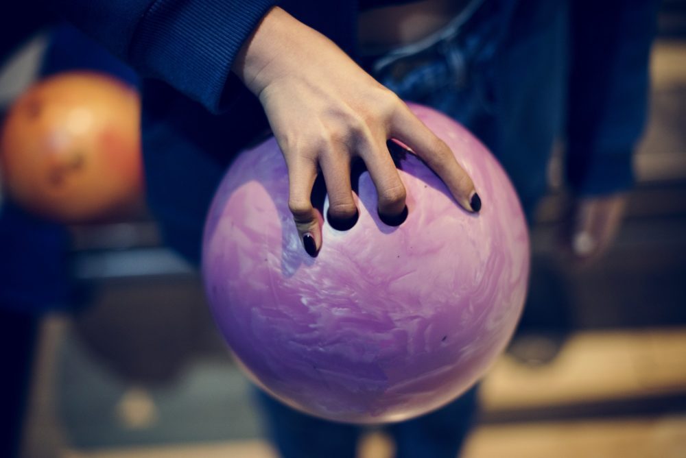 Grabbing the pink bowling ball