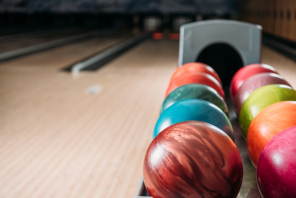 stand with colorful bowling balls in club
