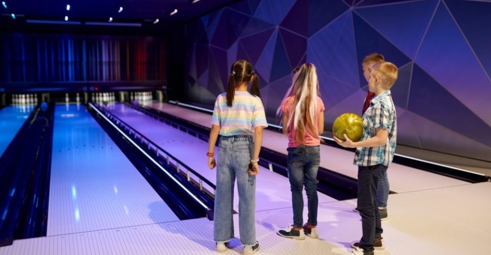Group of children on the lane in bowling alley
