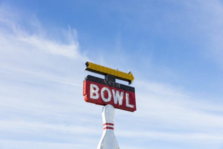 Vintage sign for bowling alley, Bowl white lettering on red background - ancient bowling ball