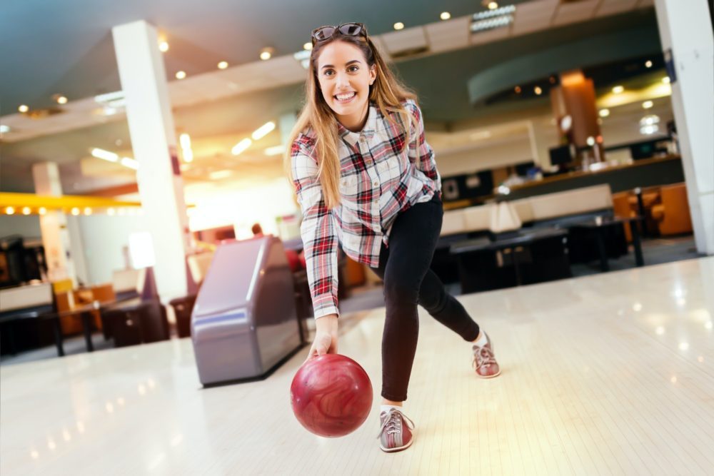 Woman throwing bowling ball - bowling invented