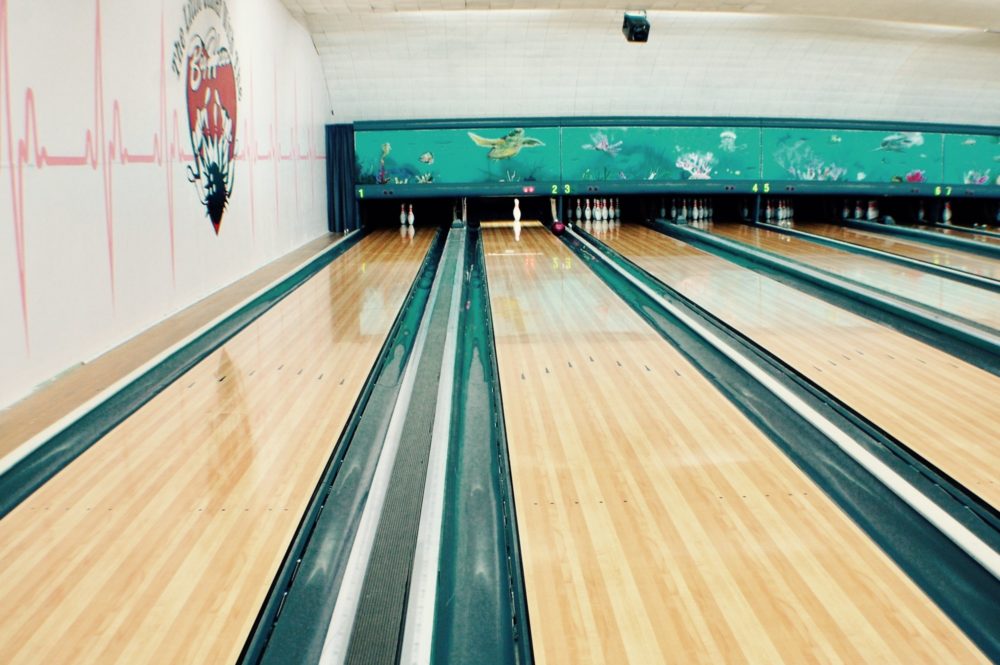 Looking down a lane at bowling alley
