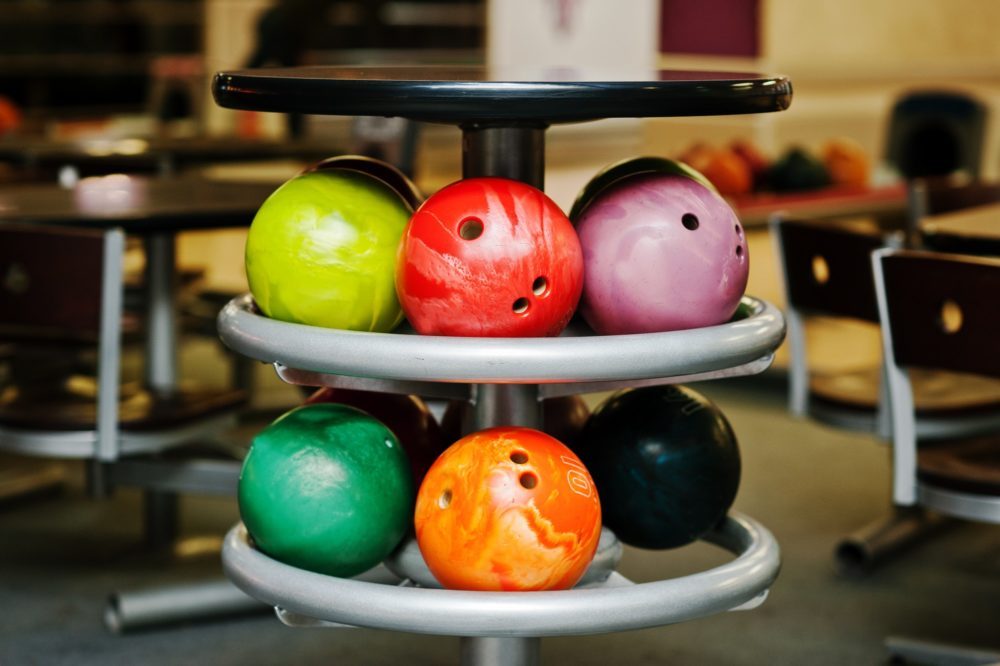 Many colored balls for bowling at table to store
