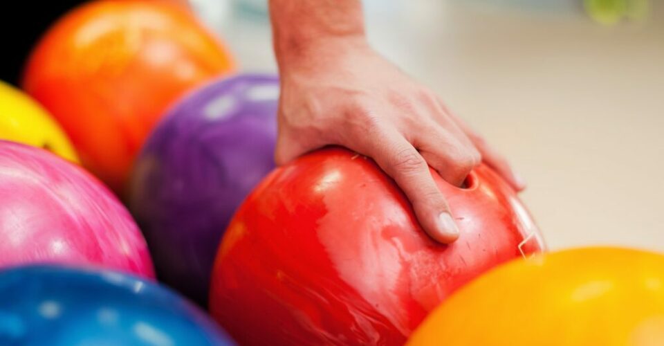 I choose this one. Close-up of a hand holding bowling ball